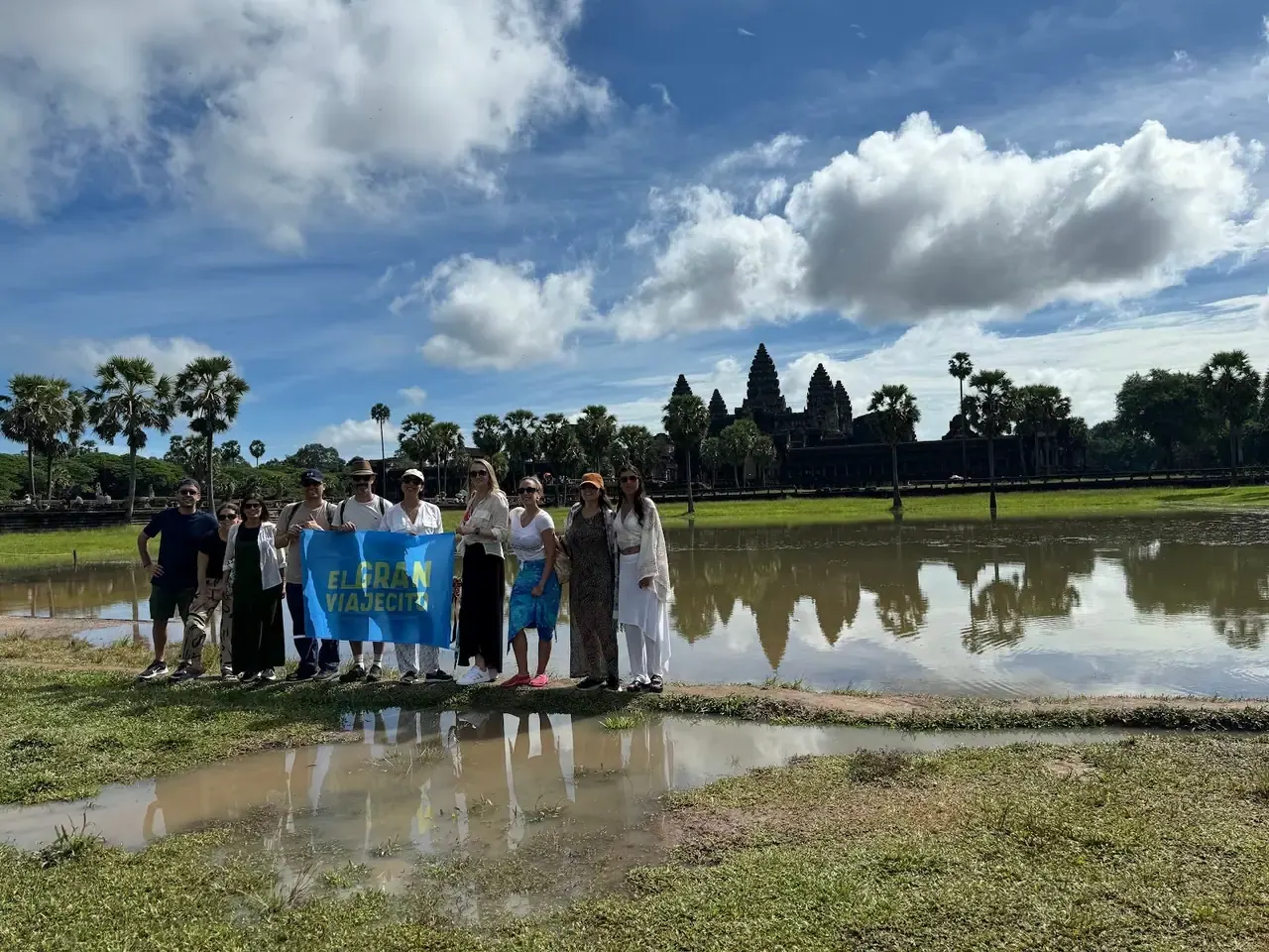 Grupo de El Gran Viajecito con la bandera en Angkor Wat.